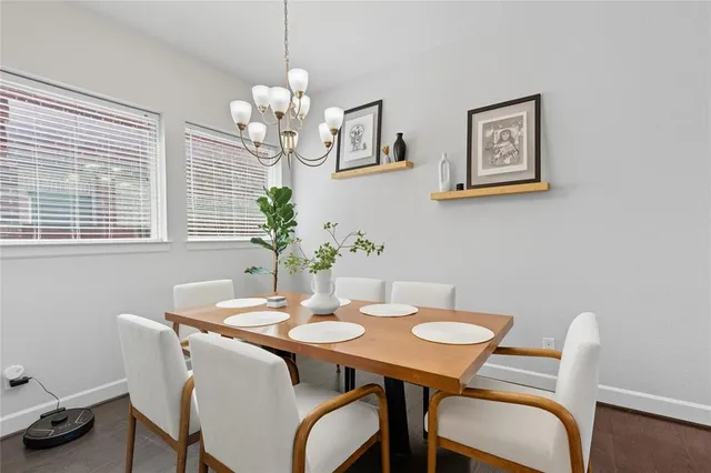 a view of a dining room with furniture and chandelier