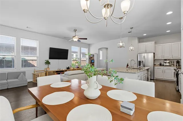 a view of a dining room with furniture a fireplace and wooden floor