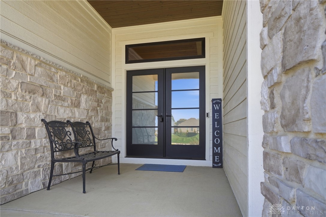 1247 Normandy Rue Dayton, OH 45458 - Photo 4 of 76 This inviting entrance features dual glass doors, offering a glimpse of the lush surroundings.