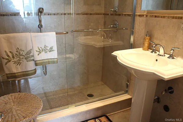 a bathroom with a shower and mirror