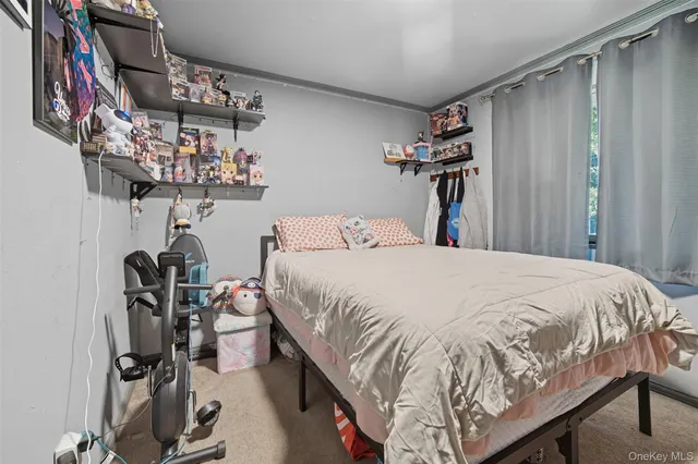 a bed sitting in a bedroom next to a window