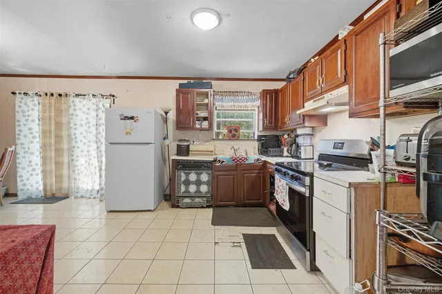 a kitchen with a sink a stove top oven and cabinets