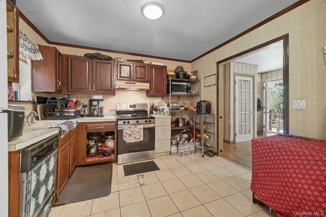 a kitchen with sink cabinets and stove top oven