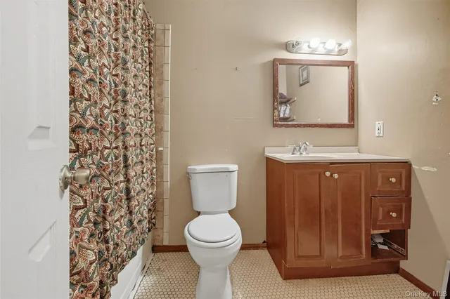 a bathroom with a toilet a sink and mirror