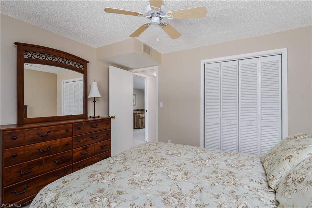 5515 Rattlesnake Hammock Road, Unit 205 Naples, FL 34113 - Photo 18 of 46 Carpeted bedroom with ceiling fan, baseboards, and access to outside