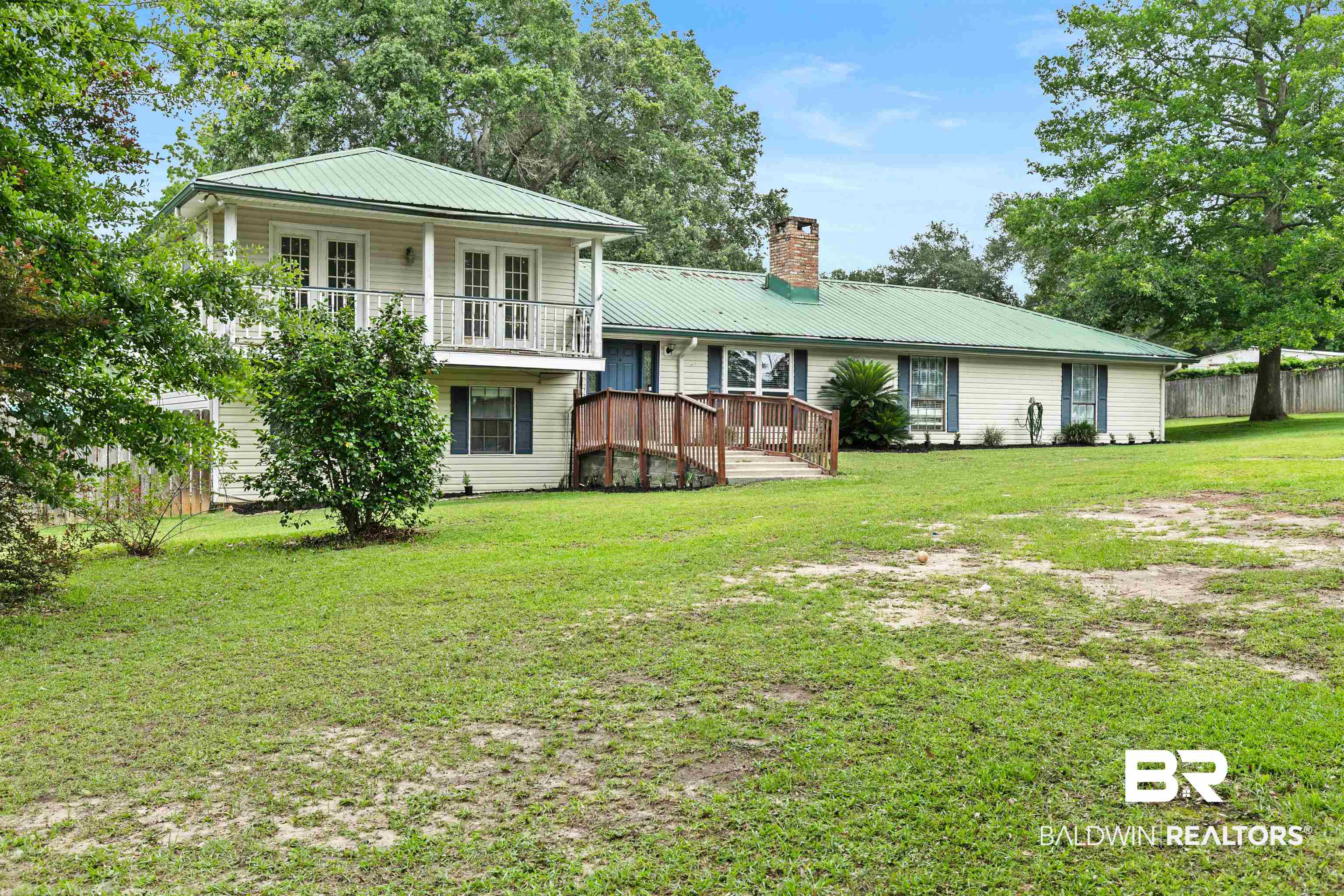 10420 Johnson Road South Mobile, AL 36695 - Photo 2 of 75 Two-story property featuring a prominent metal roof and light-colored siding
