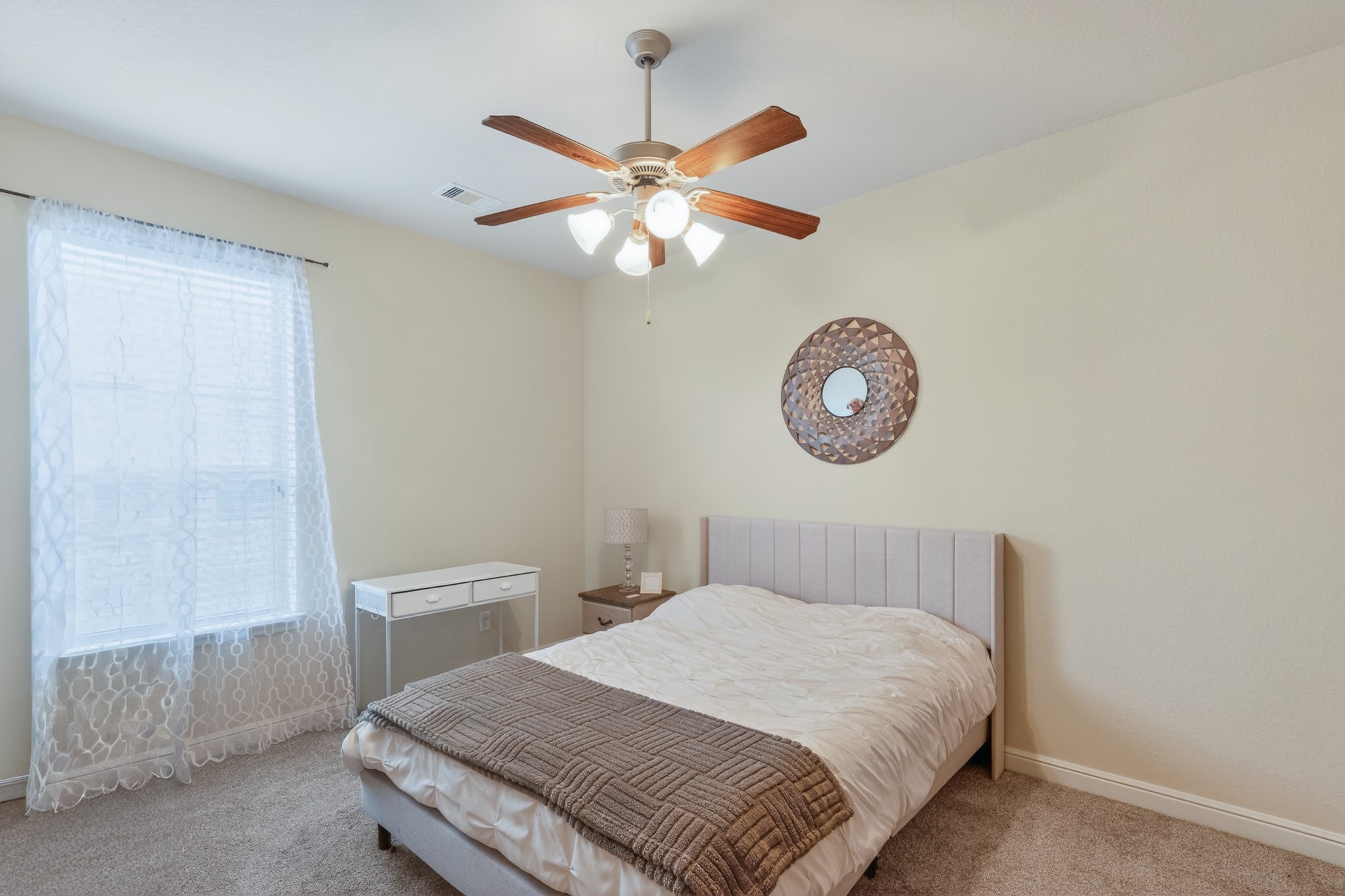 24711 East Burnaby Circle Spring, TX 77373 - Photo 16 of 20 a bedroom with a bed and a chandelier