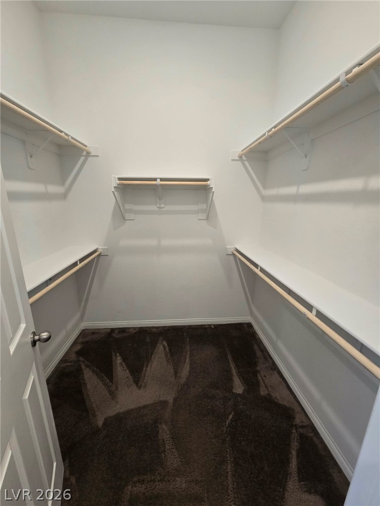 4748 Ritual Street North Las Vegas, NV 89031 - Photo 16 of 31 A spacious walk-in closet offers abundant storage with multiple shelving and hanging rod configurations.