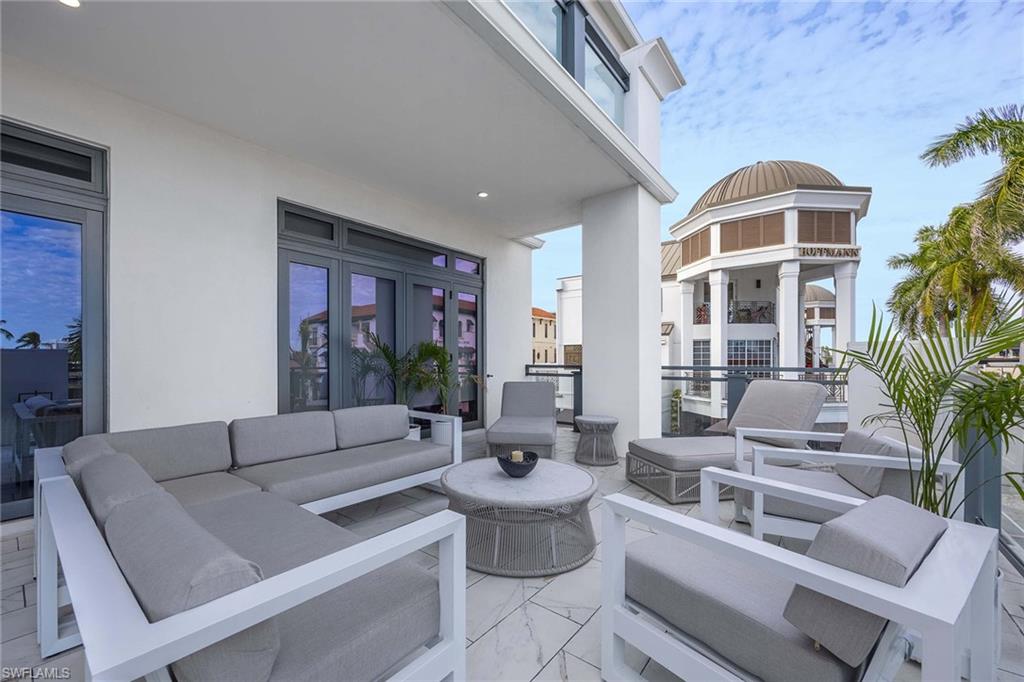 875 6th Avenue South, Unit 203 Naples, FL 34102 - Photo 21 of 49 Indoor-outdoor living perfect for dining, lounging, and entertaining