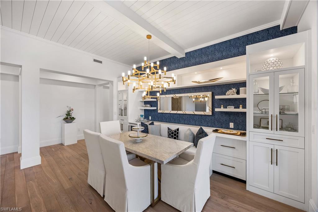 875 6th Avenue South, Unit 203 Naples, FL 34102 - Photo 25 of 49 An elegant dining area designed for connection, open to the kitchen and living room and extending naturally to the lanai.