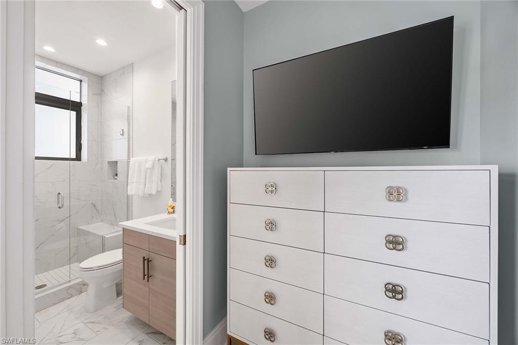 875 6th Avenue South, Unit 203 Naples, FL 34102 - Photo 27 of 49 Beautifully appointed guest bathroom with elegant finishes and a refined design.