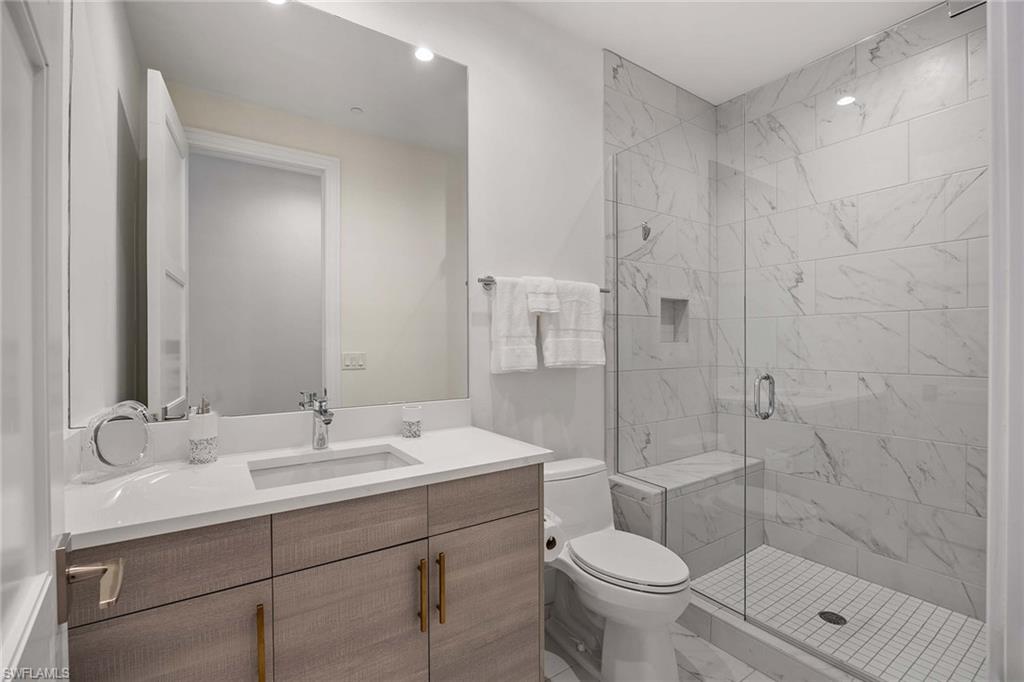 875 6th Avenue South, Unit 203 Naples, FL 34102 - Photo 30 of 49 Well-appointed guest bathroom with refined finishes and a modern aesthetic.