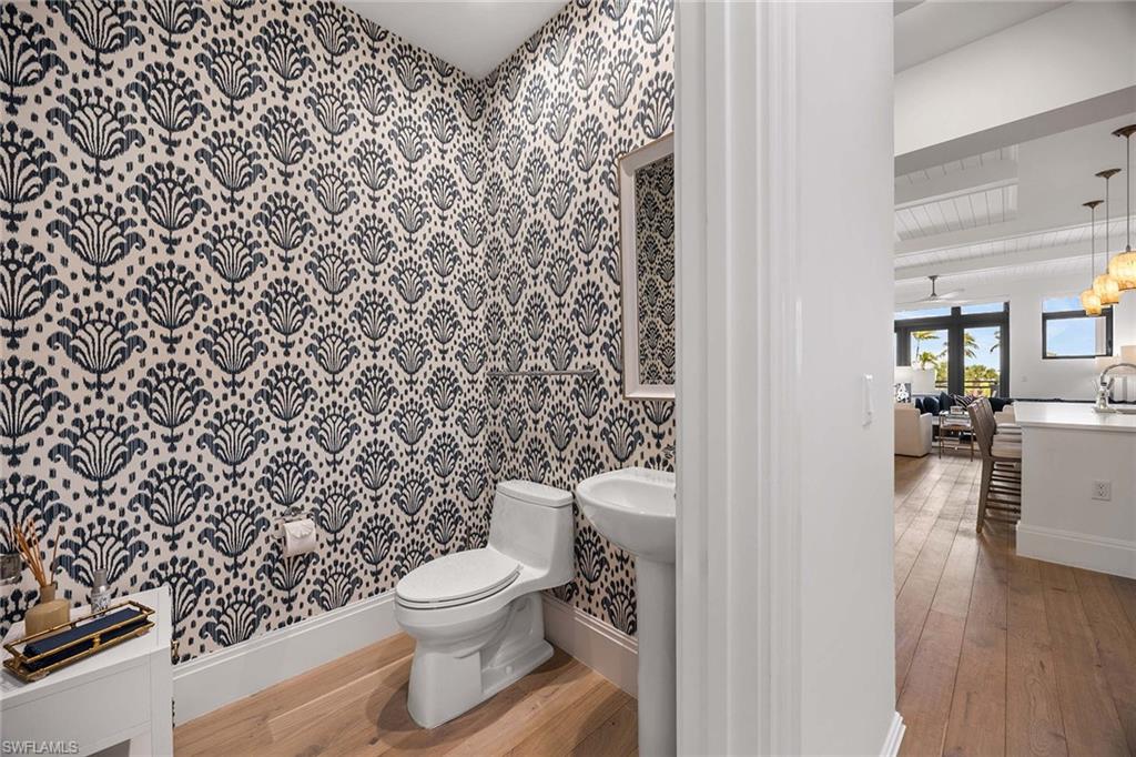 875 6th Avenue South, Unit 203 Naples, FL 34102 - Photo 31 of 49 Chic powder bath with designer wallpaper, offering a polished touch just off the main living space and entry.