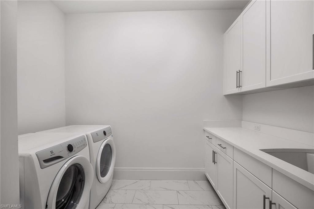 875 6th Avenue South, Unit 203 Naples, FL 34102 - Photo 32 of 49 Thoughtfully designed laundry room with Electrolux washer and dryer, quartz countertops, sink, and generous custom cabinetry.