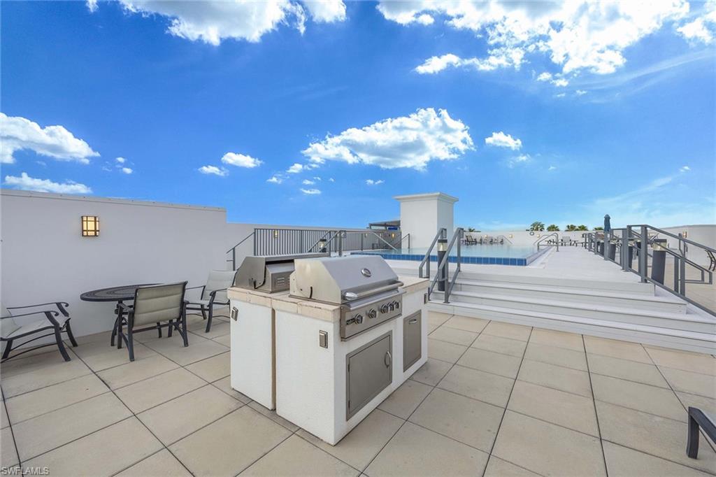 875 6th Avenue South, Unit 203 Naples, FL 34102 - Photo 39 of 49 Entertain with ease at the rooftop grilling stations, set beside the pool in a relaxed, resort-style setting.