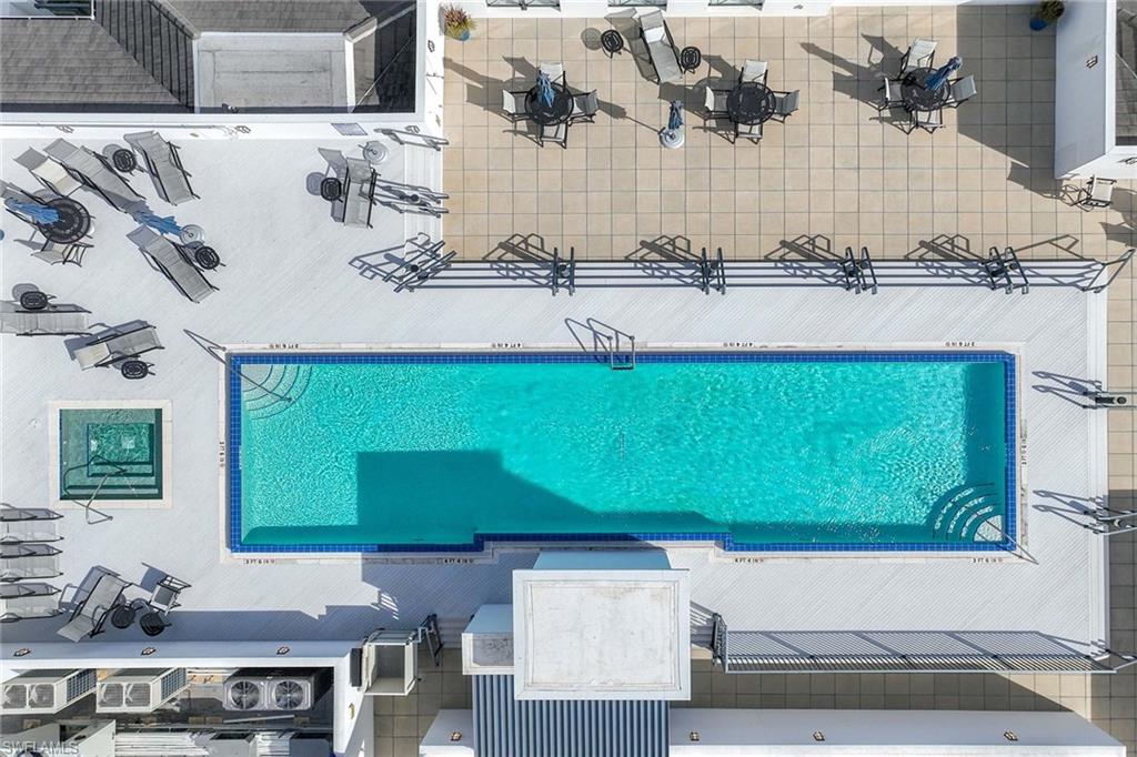875 6th Avenue South, Unit 203 Naples, FL 34102 - Photo 40 of 49 Resort-style rooftop pool with city views, lounge seating, and an elevated downtown atmosphere.