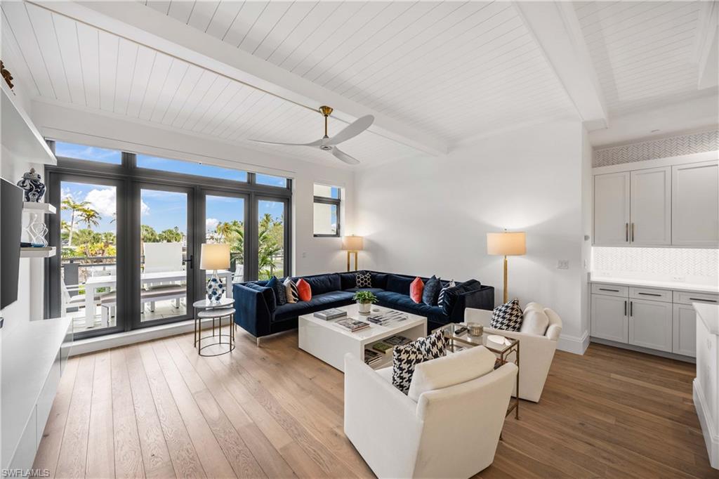 875 6th Avenue South, Unit 203 Naples, FL 34102 - Photo 4 of 49 Light-filled living area with seamless indoor-outdoor flow to the expansive lanai.