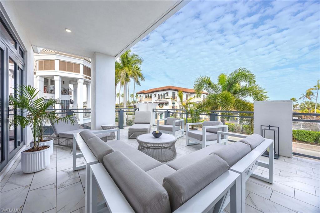 875 6th Avenue South, Unit 203 Naples, FL 34102 - Photo 5 of 49 Spacious, oversized lanai with a large seating area overlooking the city—ideal for relaxing, entertaining, and enjoying vibrant downtown views.