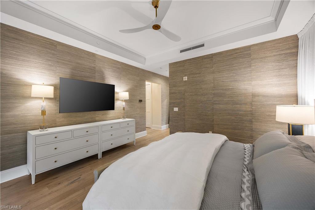 875 6th Avenue South, Unit 203 Naples, FL 34102 - Photo 7 of 49 Primary bedroom retreat appointed with luxurious Matouk bedding and an elegant, calming aesthetic.