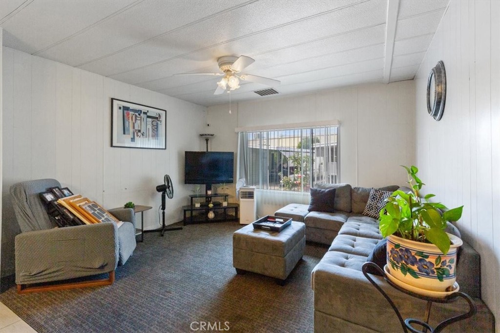300 North Rampart Street, Unit 195 Orange, CA 92868 - Photo 11 of 25 a living room with furniture and a flat screen tv