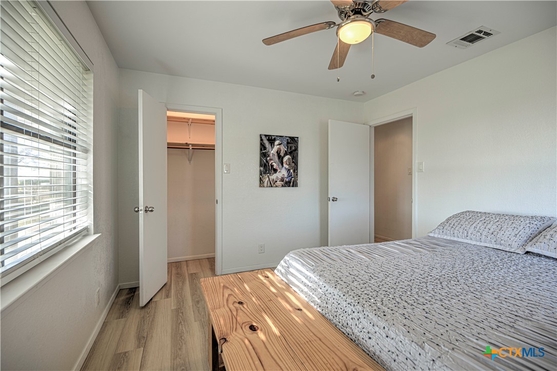 8510 Burgandy Lane Temple, TX 76504 - Photo 20 of 48 a bedroom with a bed and a chandelier