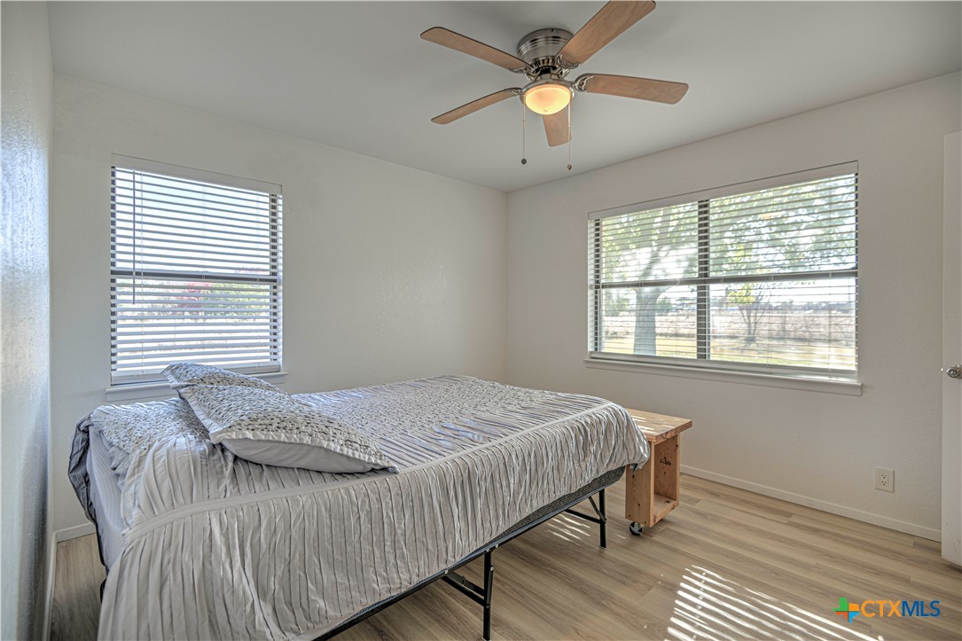 8510 Burgandy Lane Temple, TX 76504 - Photo 21 of 48 a bedroom with a large bed chandelier and a window