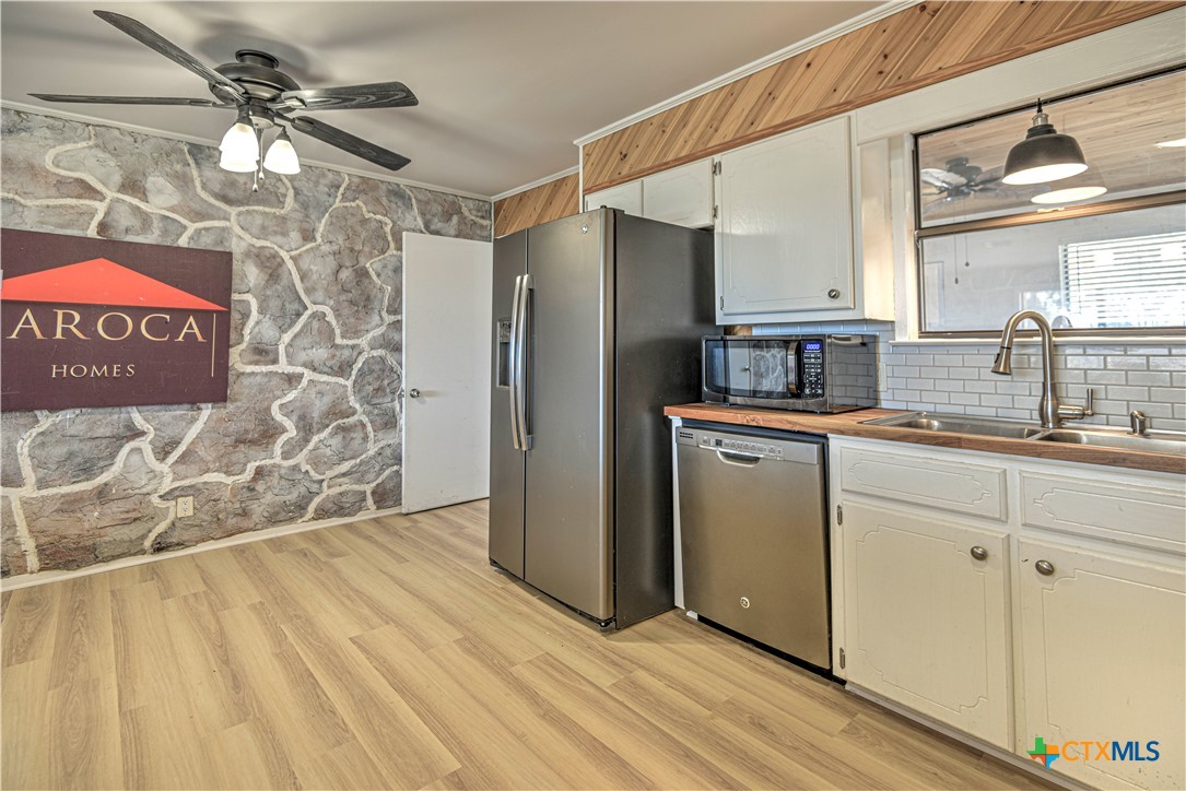 8510 Burgandy Lane Temple, TX 76504 - Photo 8 of 48 a kitchen with stainless steel appliances granite countertop a refrigerator a sink and white cabinets