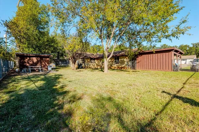 a view of swimming pool with outdoor seating and yard