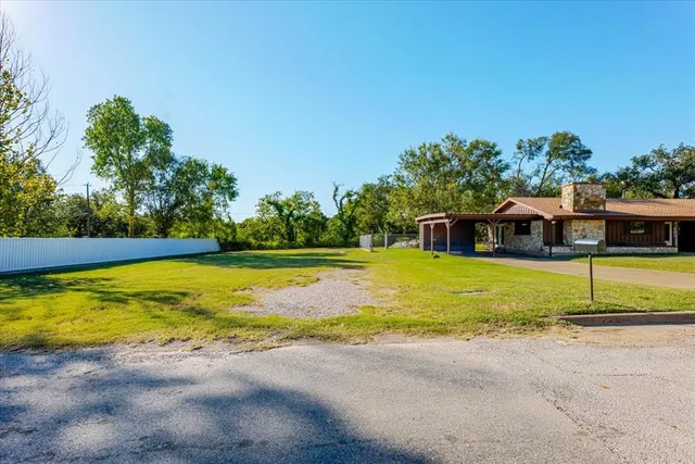 a view of an swimming pool with a yard