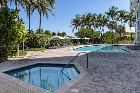 a view of backyard with swimming pool and chair