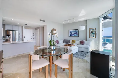 a living room with furniture kitchen and a table