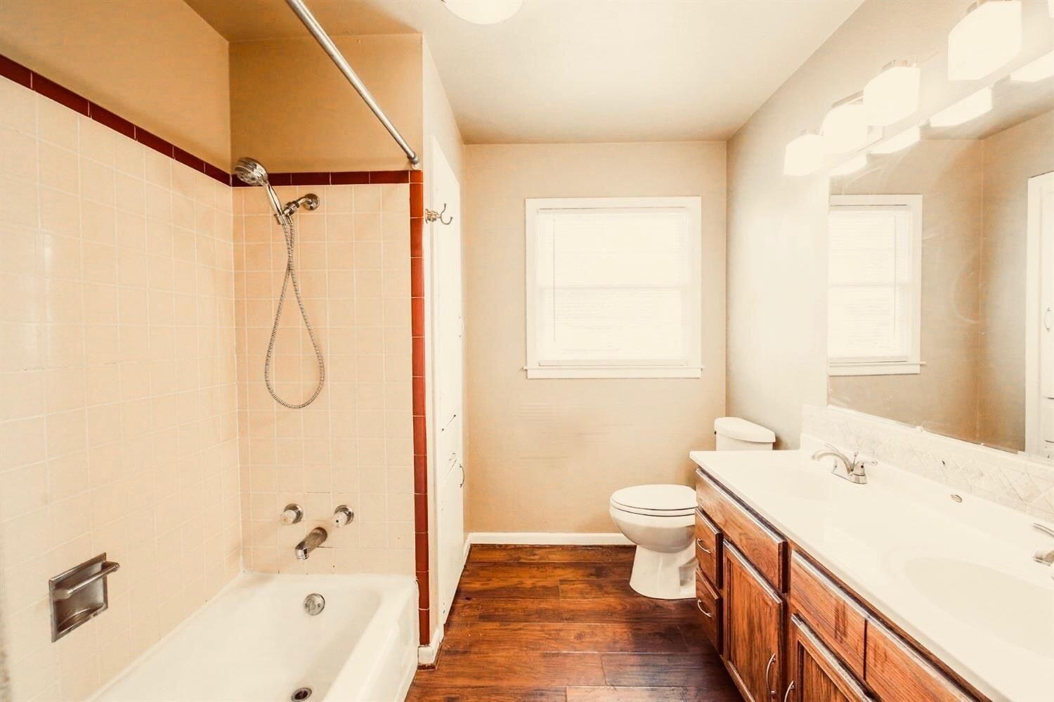 3809 25th Street Lubbock, TX 79410 - Photo 5 of 8 a bathroom with a sink a toilet and shower