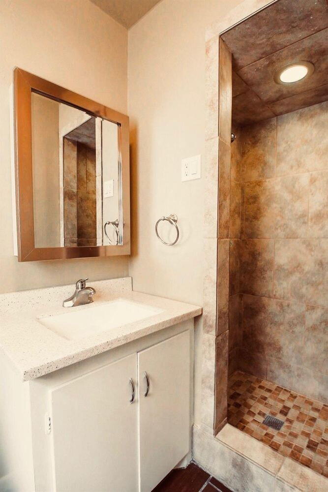 3809 25th Street Lubbock, TX 79410 - Photo 7 of 8 a bathroom with a sink and a mirror