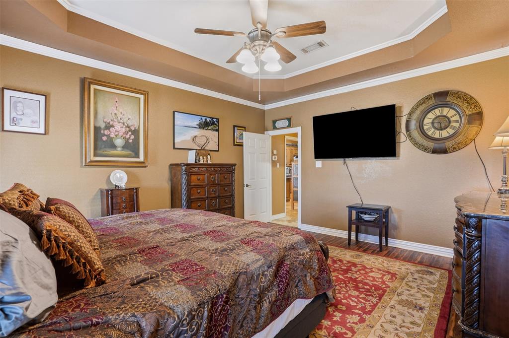 7229 County Road 1205 Rio Vista, TX 76093 - Photo 12 of 40 a spacious bedroom with a bed and a flat screen tv