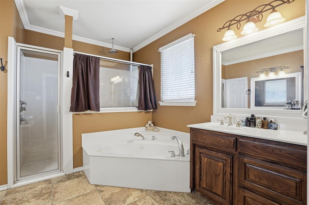 7229 County Road 1205 Rio Vista, TX 76093 - Photo 13 of 40 a bathroom with a tub a sink and mirror