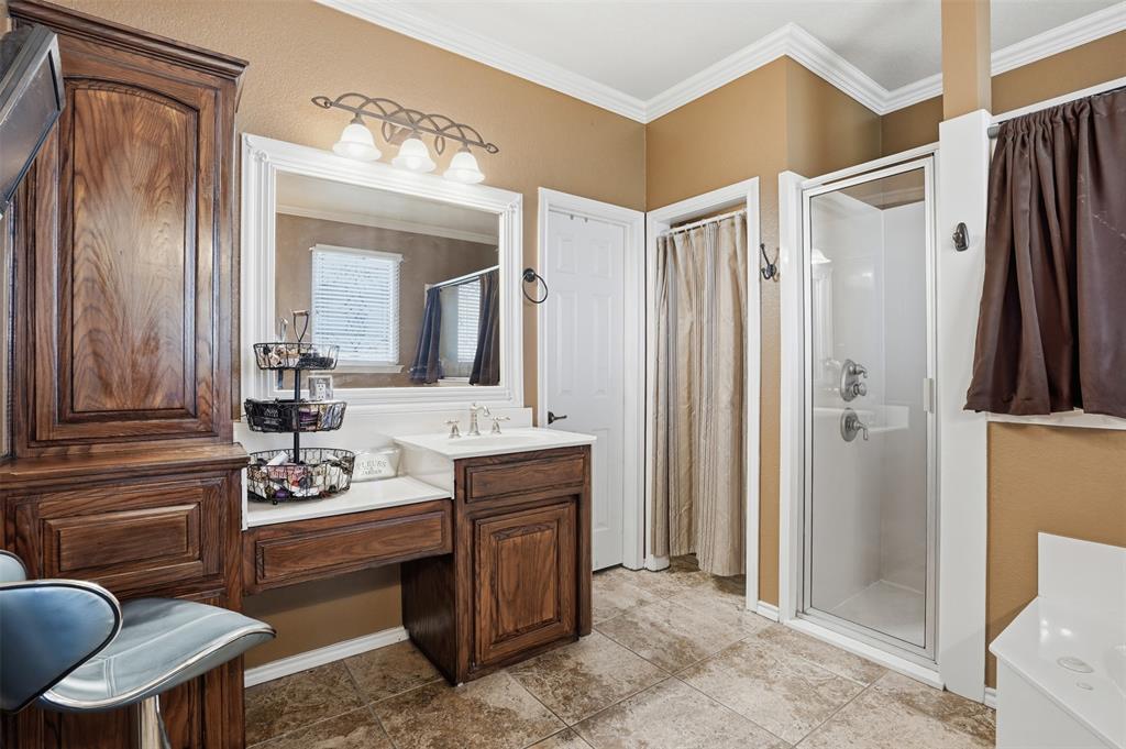 7229 County Road 1205 Rio Vista, TX 76093 - Photo 14 of 40 a bathroom with a sink a mirror a toilet and a shower