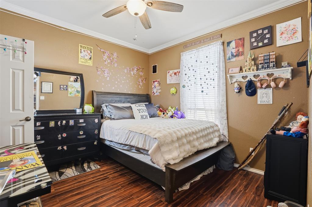 7229 County Road 1205 Rio Vista, TX 76093 - Photo 21 of 40 a bedroom with a bed and wooden floor