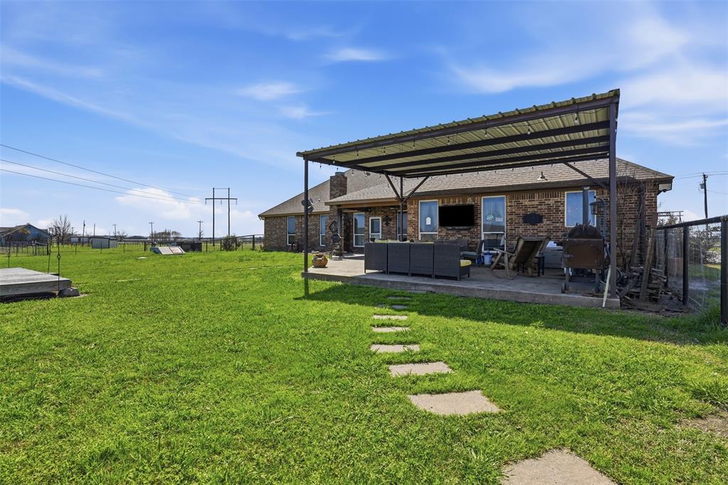 7229 County Road 1205 Rio Vista, TX 76093 - Photo 25 of 40 a backyard of a house with table and chairs