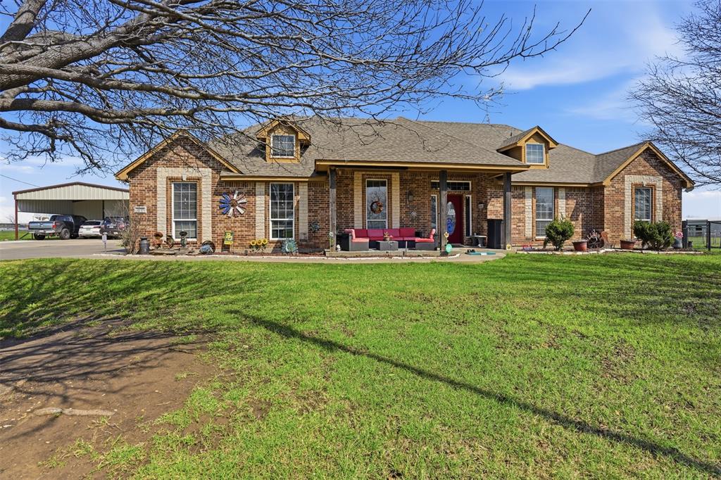 7229 County Road 1205 Rio Vista, TX 76093 - Photo 3 of 40 a front view of a house with a big yard and large trees