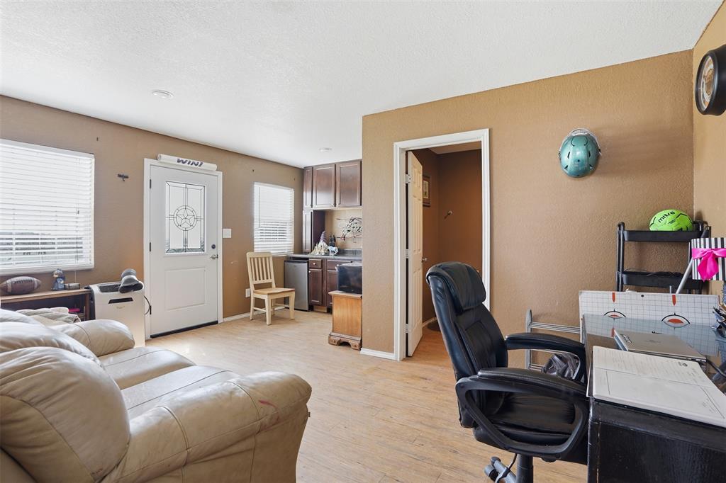 7229 County Road 1205 Rio Vista, TX 76093 - Photo 33 of 40 a living room with furniture and a wooden floor