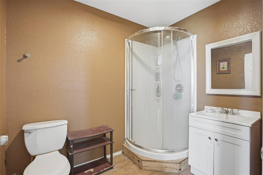 7229 County Road 1205 Rio Vista, TX 76093 - Photo 35 of 40 a bathroom with a toilet and a shower