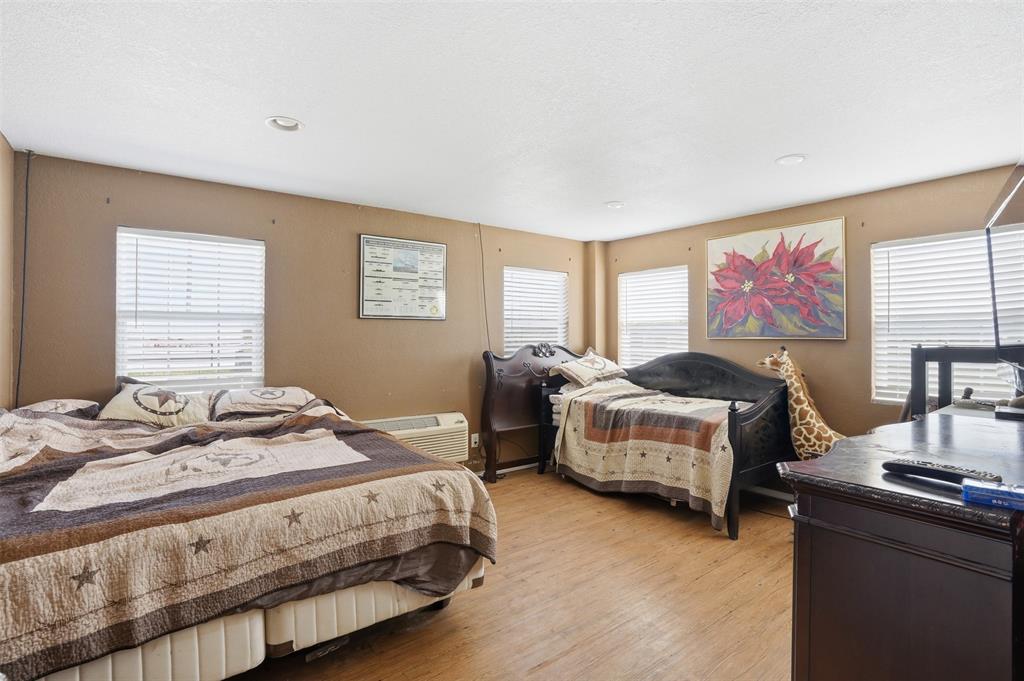 7229 County Road 1205 Rio Vista, TX 76093 - Photo 36 of 40 a bedroom with a bed and a couch
