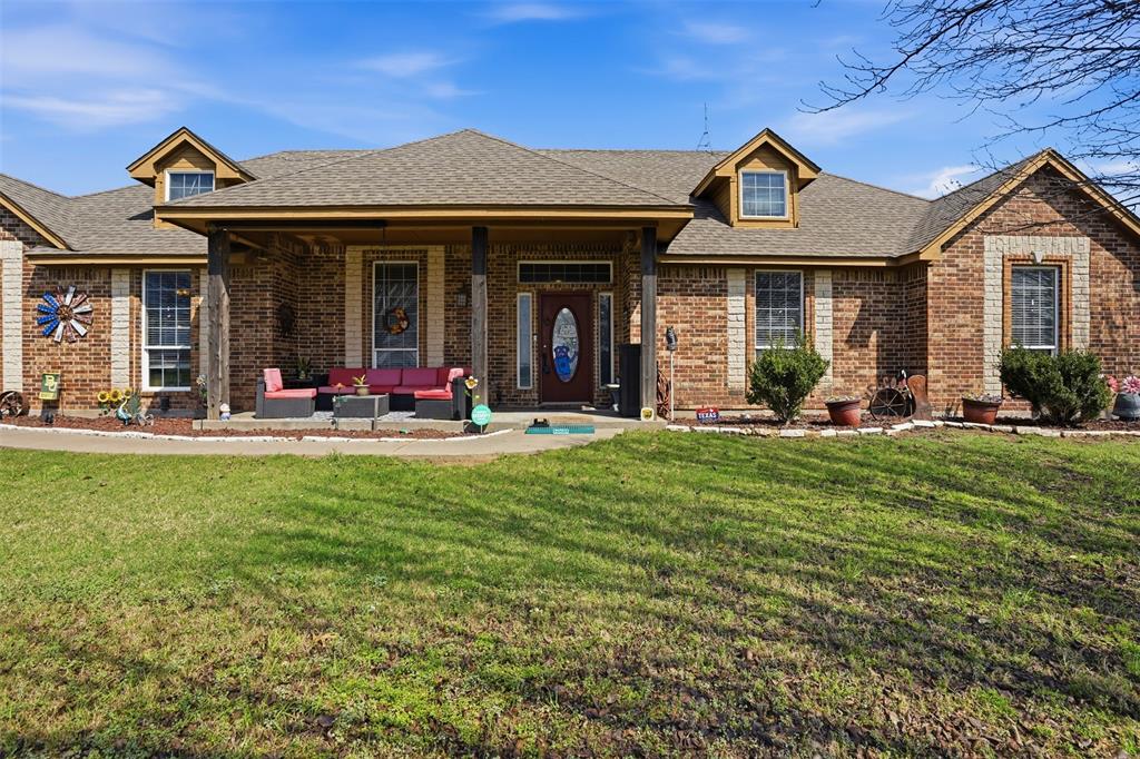 7229 County Road 1205 Rio Vista, TX 76093 - Photo 4 of 40 a front view of a house with a garden and plants