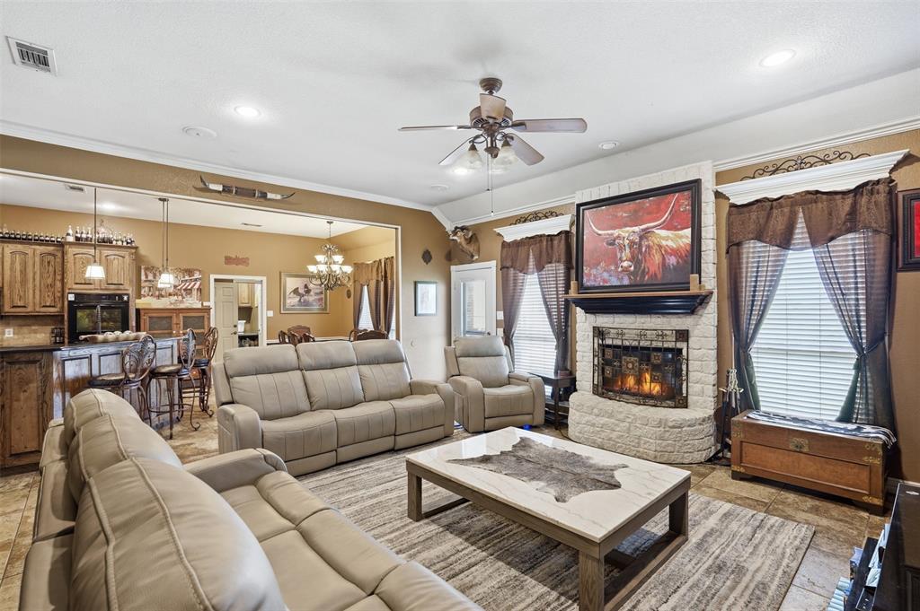 7229 County Road 1205 Rio Vista, TX 76093 - Photo 7 of 40 a living room with furniture and a fireplace