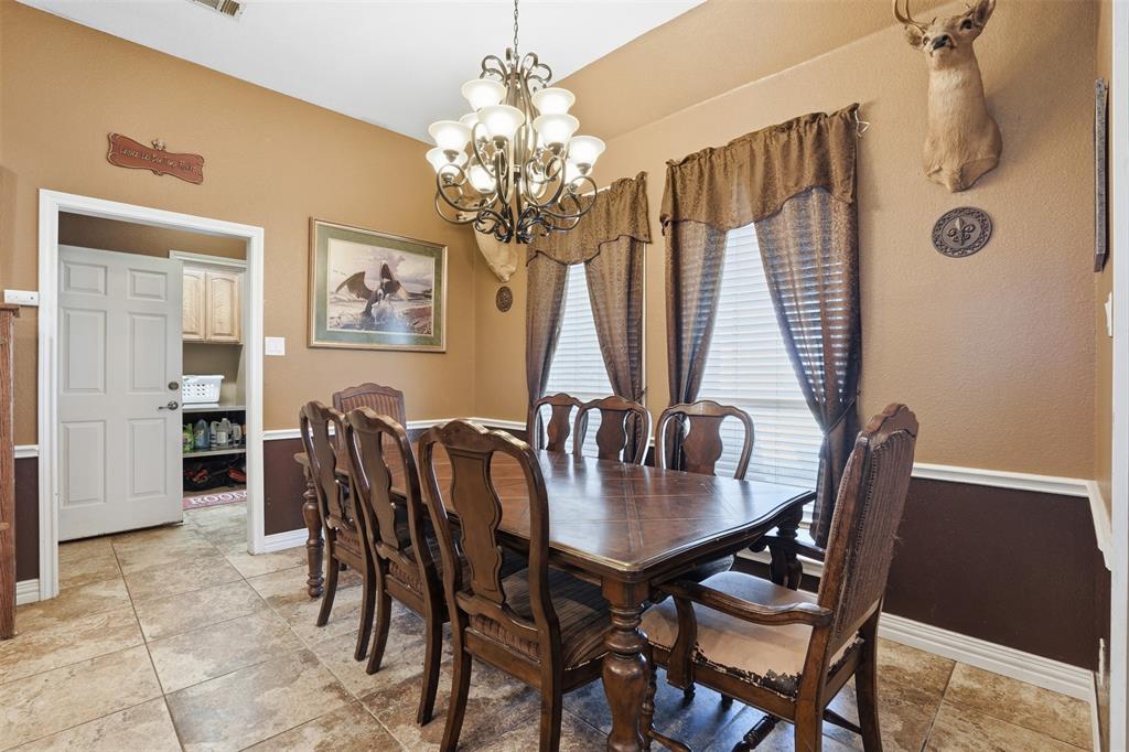 7229 County Road 1205 Rio Vista, TX 76093 - Photo 9 of 40 a view of a dining room with furniture and chandelier