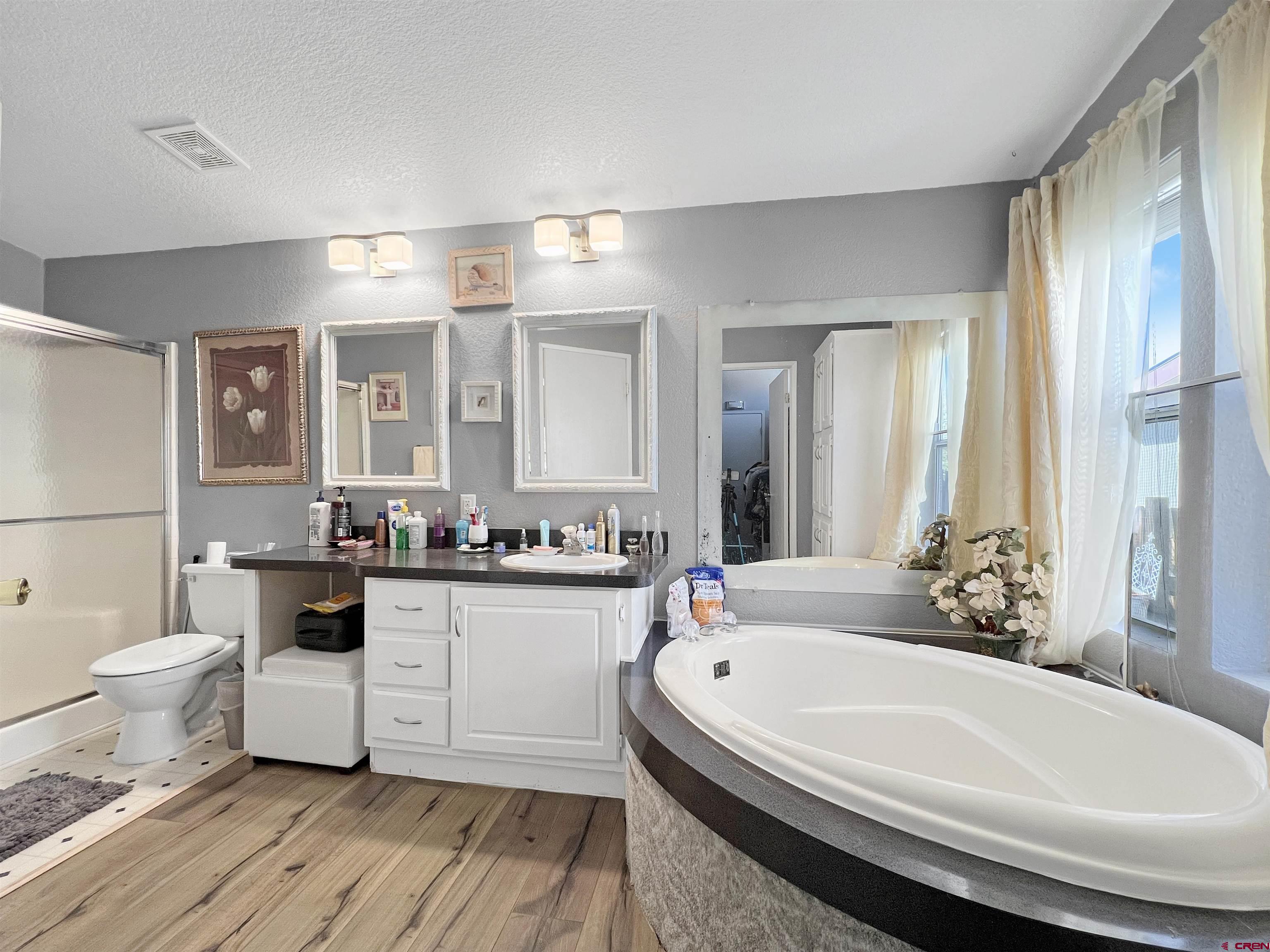 635 Fox Court Delta, CO 81416 - Photo 11 of 22 a bathroom with a granite countertop sink and a bathtub