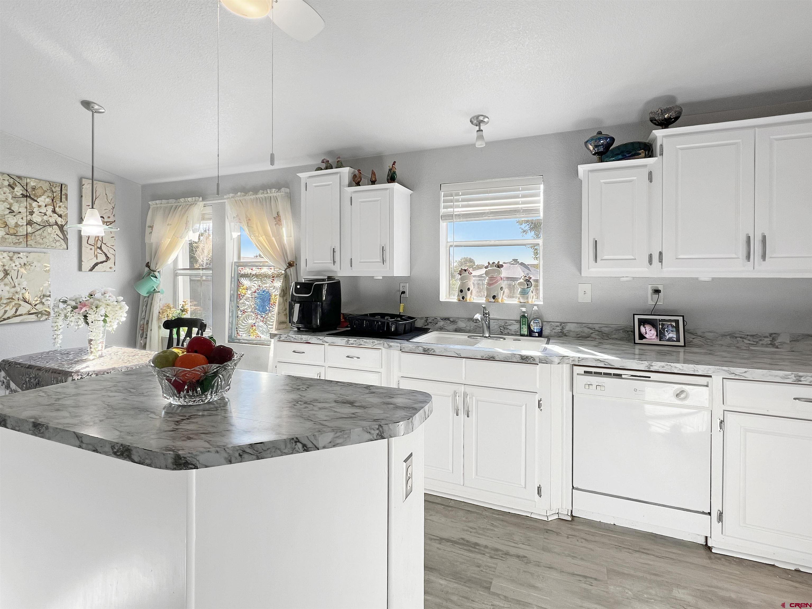 635 Fox Court Delta, CO 81416 - Photo 5 of 22 a kitchen with stainless steel appliances granite countertop a sink a stove and white cabinets