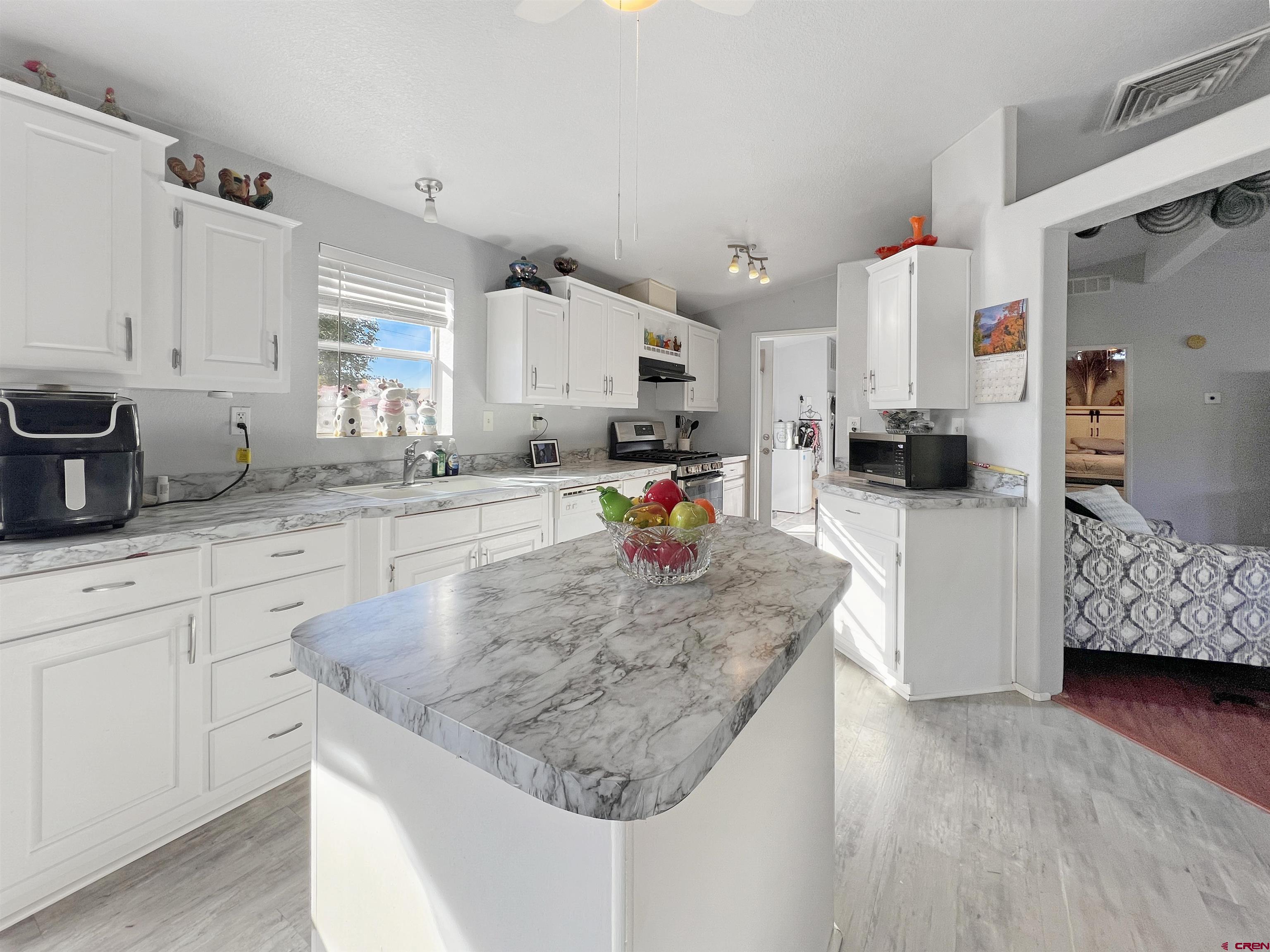 635 Fox Court Delta, CO 81416 - Photo 6 of 22 a kitchen with granite countertop a sink a stove and cabinets