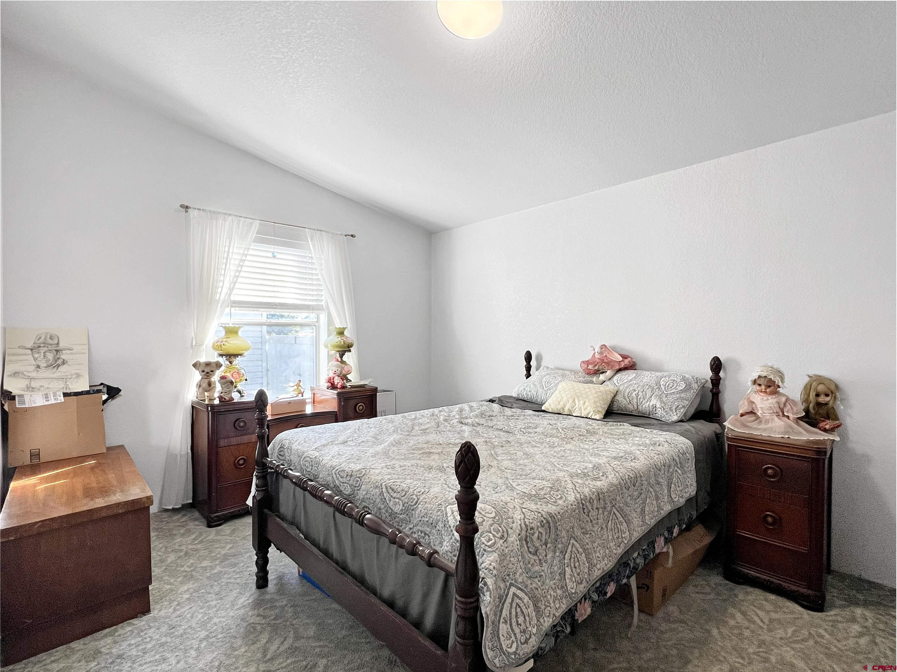 635 Fox Court Delta, CO 81416 - Photo 9 of 22 a bedroom with a bed and a chandelier