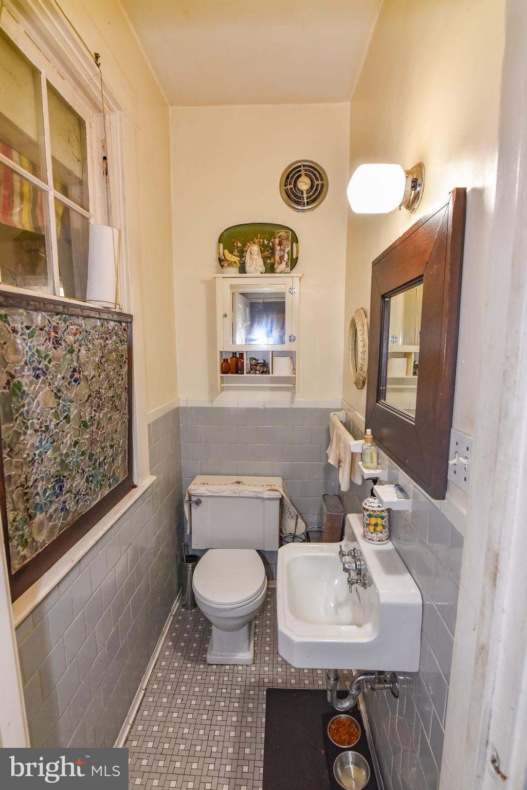 24 Merrymount Road Baltimore, MD 21210 - Photo 14 of 48 a bathroom with a toilet sink and mirror
